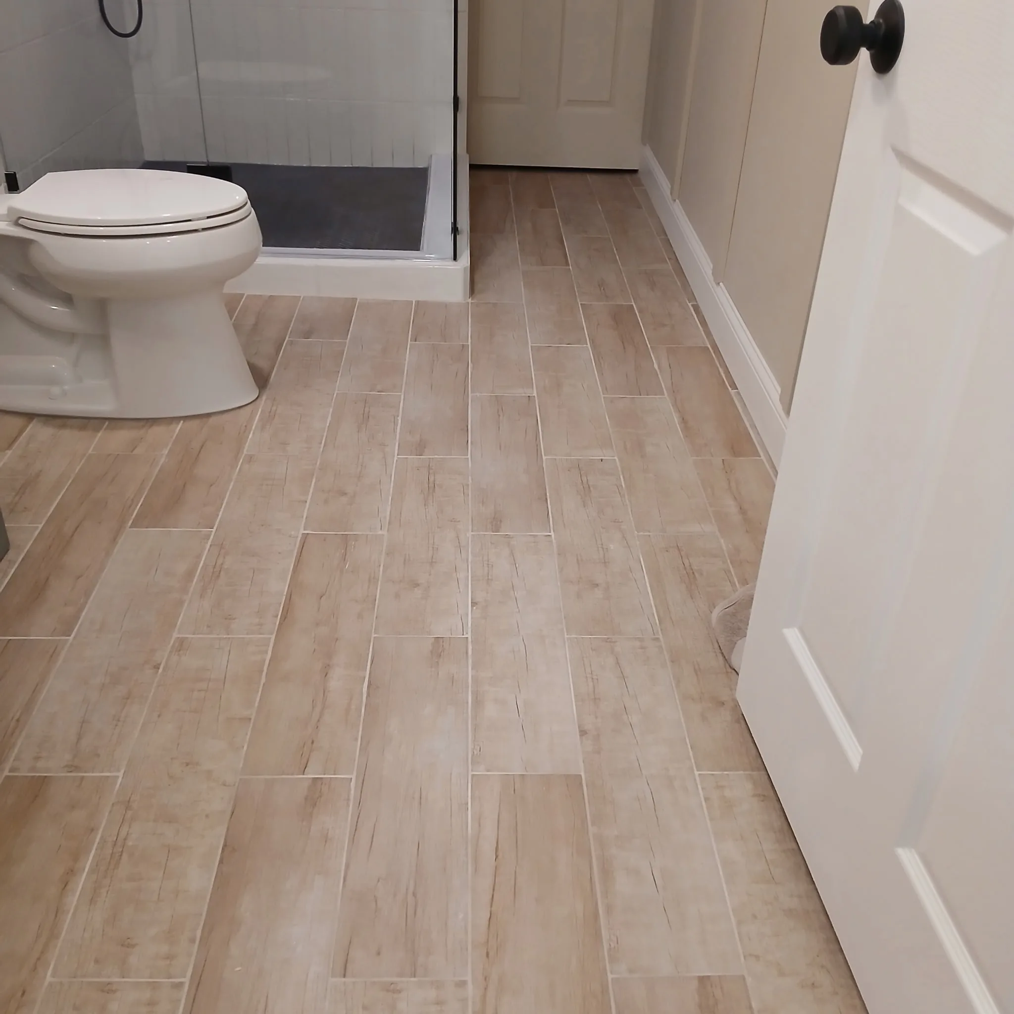 Finished bathroom with wood-look tile flooring